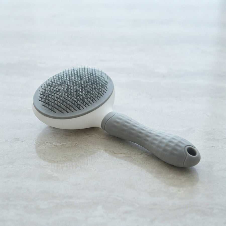 SleekStroke Brush in gray — self-cleaning pet grooming brush for dogs and cats